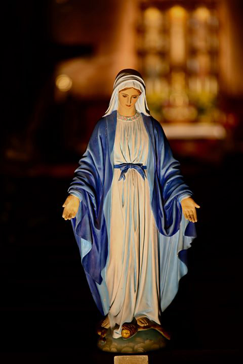 Statue of the Blessed Mother with the main altar in the background
